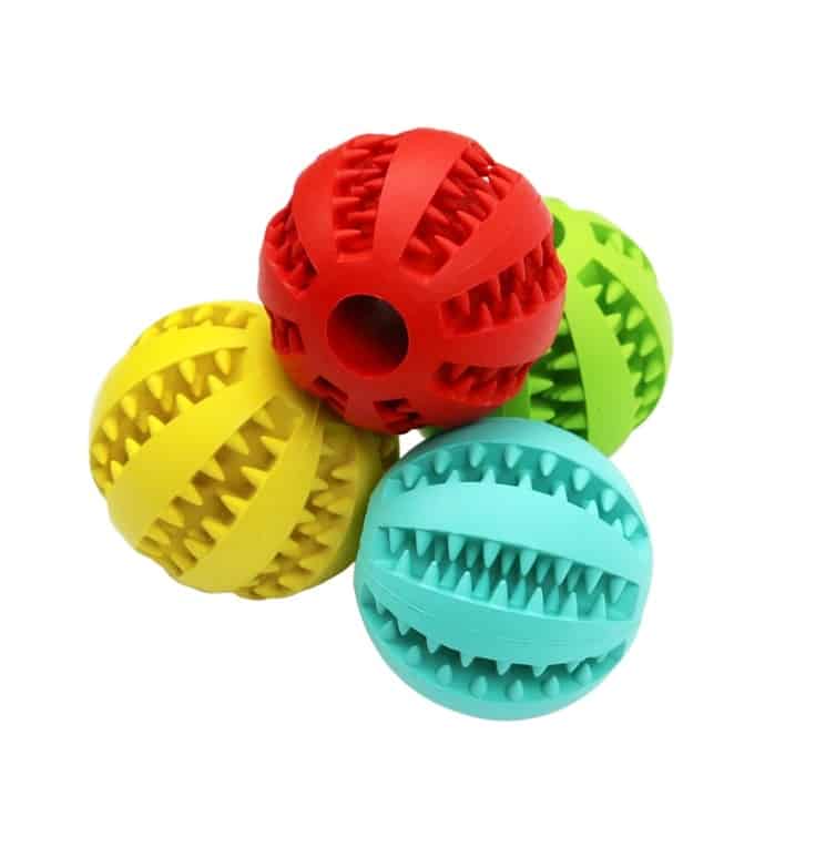 the image contains 4 different colors of dog feeder balls